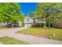 Charming home featuring a well-maintained lawn, two-car garage, and inviting entryway at 3568 Oakshire Se Way, Atlanta, GA 30354