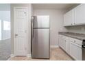 Well-lit kitchen with stainless steel refrigerator, ample cabinet space, and neutral countertops at 3568 Oakshire Se Way, Atlanta, GA 30354