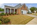 Beautiful home with a two-car garage, manicured lawn, and lovely landscaping at 4265 Prince Charles Dr, Duluth, GA 30097