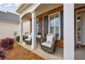 Cozy front porch features comfortable seating and charming decor, perfect for relaxing at 4265 Prince Charles Dr, Duluth, GA 30097