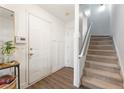 Inviting foyer with a staircase, wood floors, and a white front door at 745 Abbotts Mill Ct, Johns Creek, GA 30097