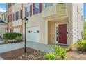 Charming front entry with a brick accent, a well-manicured lawn and red door at 745 Abbotts Mill Ct, Johns Creek, GA 30097