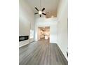 Bright living room with soaring ceilings, modern fireplace, and sleek wood flooring at 123 Deer Xing, Temple, GA 30179