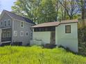 Street view of home highlighting its proximity to a neighbor and landscaping at 1846 Markone Nw St, Atlanta, GA 30318