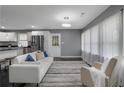 Bright living room featuring a comfortable couch, modern lighting, and an open floorplan at 2681 Tilson Rd, Decatur, GA 30032