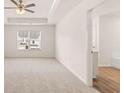 Spacious bedroom with a tray ceiling, fan, and lots of natural light at 290 Silver Moon Drive # 111, Loganville, GA 30052