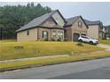 Beautiful home featuring brick accents, an attached two-car garage and lawn at 1750 Stone Meadow Rd, Lithonia, GA 30058