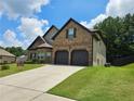 Charming two-story brick home with a well-manicured lawn and two-car garage at 1750 Stone Meadow Rd, Lithonia, GA 30058