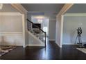 Inviting entryway with hardwood floors, elegant chandelier, staircase and trim accents at 552 Warrenton Run Dr, Sugar Hill, GA 30518