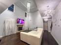 This elegant living room offers a fireplace, tall windows and modern chandelier at 552 Warrenton Run Dr, Sugar Hill, GA 30518