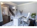 Bright home office with a white desk, chair, and exercise equipment, offering a functional workspace at 552 Warrenton Run Dr, Sugar Hill, GA 30518
