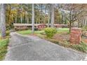 Beautiful brick home nestled among tall trees, featuring a lush lawn and inviting curb appeal at 1868 Fort Valley Sw Dr, Atlanta, GA 30311