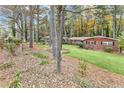 Charming brick home surrounded by mature trees and landscaping offers a serene and private setting at 1868 Fort Valley Sw Dr, Atlanta, GA 30311