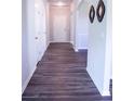 Inviting hallway with wood floors, fresh paint, and decorative accents on the wall at 233 Bloomfield Cir, Canton, GA 30114
