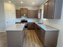 Modern kitchen features stainless appliances, granite countertops, and center island at 233 Bloomfield Cir, Canton, GA 30114