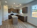 Modern kitchen features stainless appliances, granite countertops, and center island at 233 Bloomfield Cir, Canton, GA 30114