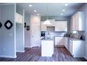 Modern kitchen featuring white cabinets, granite countertops, and a stylish center island at 233 Bloomfield Cir, Canton, GA 30114