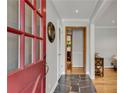 View of the home's foyer showing the unique flooring and front door with glass panels at 2799 Briarglen Dr, Atlanta, GA 30340