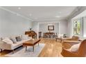 Spacious living room featuring hardwood floors, a large bay window, and an open floor plan at 2799 Briarglen Dr, Atlanta, GA 30340