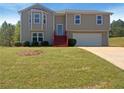 Charming two-story home featuring a bay window, red steps, and an attached two-car garage at 55 Ratliff Dr, Covington, GA 30016