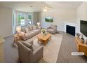 Bright living room with large windows, a fireplace, ceiling fan, and neutral decor at 55 Ratliff Dr, Covington, GA 30016