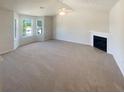 Bright living room with large windows, a fireplace, and neutral decor at 55 Ratliff Dr, Covington, GA 30016