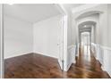Hallway featuring detailed trim, arched entryway and hardwood flooring at 667 Creswell Park, Smyrna, GA 30082