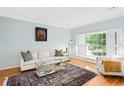 Bright living room with hardwood floors, large windows with shutters, and classic decor at 1817 Bedfordshire Dr, Decatur, GA 30033
