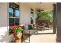 Inviting covered front porch furnished with a comfortable couch, chairs, and a small table with a fan overhead at 235 South St, Buford, GA 30518