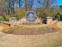 Elegant stone entrance sign for Bright Water, surrounded by lush landscaping and colorful flower beds at 2553 Twilight Vw, Snellville, GA 30078