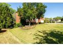 Well-maintained front yard with lush lawn, mature trees, and landscaping surrounding an elegant brick home at 2553 Twilight Vw, Snellville, GA 30078