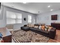 Stylish living room featuring a plush sectional, patterned rug, and natural light at 1929 Millstream Holw, Conyers, GA 30012