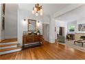 Welcoming foyer featuring hardwood floors, elegant lighting, and staircase at 22 The Prado Ne, Atlanta, GA 30309