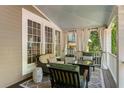 Relaxing covered porch featuring comfortable seating and neutral toned curtains at 22 The Prado Ne, Atlanta, GA 30309