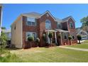 Beautiful two-story home with a brick facade, lush green lawn, and a welcoming entrance at 2347 Fawn Hollow Ct, Duluth, GA 30096