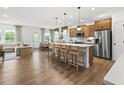 Open-concept kitchen with a large island, stainless steel appliances, and hardwood floors at 6100 Marigold Way, Atlanta, GA 30349