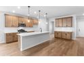 Bright kitchen with stainless appliances, wood cabinets, white countertops and island with pendant lighting at 6100 Marigold Way, Atlanta, GA 30349