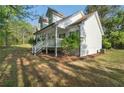 View of home with covered porch and stairs leading to yard at 280 Old Carrollton Rd, Carrollton, GA 30116