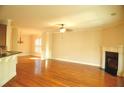 Bright, open living room with fireplace, hardwood floors, and elegant architectural details at 5122 Micaela Way, Duluth, GA 30096
