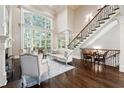 Elegant living room with soaring ceilings, fireplace, and large windows at 811 Flathead Pass, Suwanee, GA 30024