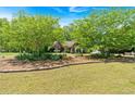 Beautifully landscaped yard with large trees, creating a serene and inviting atmosphere around the brick home at 4309 Milford Pl, Hoschton, GA 30548