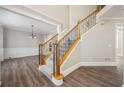 Elegant foyer with hardwood floors, staircase, and decorative chandelier at 5737 Russell Ct, Douglasville, GA 30135