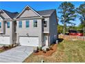 Charming, newly built townhome with a two-car garage, neutral color palette, and fresh landscaping at 1207 Fern Ridge Ct # 15, Norcross, GA 30093