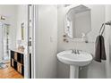 Clean and modern half-bath with pedestal sink and hardwood flooring at 1723 Highlands Se Vw, Smyrna, GA 30082