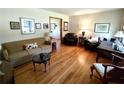 Cozy living room featuring hardwood floors, ample seating, and natural light at 3556 Forest Hill Rd, Powder Springs, GA 30127