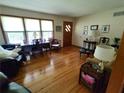 Bright living room with hardwood floors, large windows, and comfortable furnishings at 3556 Forest Hill Rd, Powder Springs, GA 30127