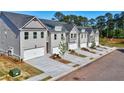 Street view of new construction townhomes with individual driveways and gray color scheme at 1217 Fern Ridge Ct # 16, Norcross, GA 30093