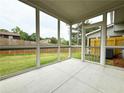 Enclosed porch with screens offers an airy view of the fenced backyard at 1237 Fern Ridge Ct # 18, Norcross, GA 30093