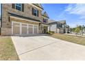 Two-story home featuring a stone facade and a spacious two-car garage, complemented by a well-maintained lawn at 1602 Dover Creek Ln, Lawrenceville, GA 30045