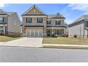 Beautiful two-story home featuring a stone facade, attached two-car garage, and inviting front lawn at 1602 Dover Creek Ln, Lawrenceville, GA 30045